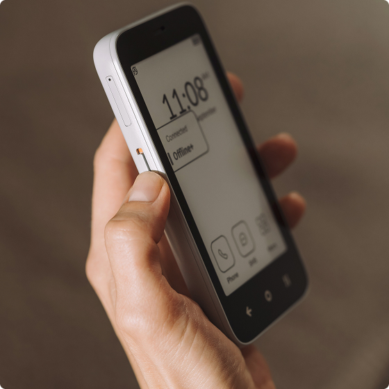 Best Dumb Phones in 2026: The Minimalist Phones That Actually Make Sense Mudita Kompakt E Ink minimalist phone held in one hand.